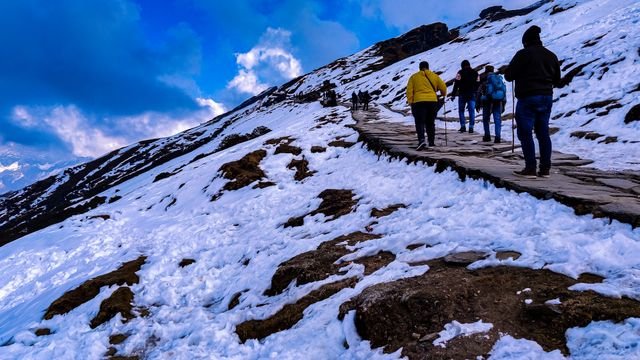 Trekkers on stone path Chopta Tungnath